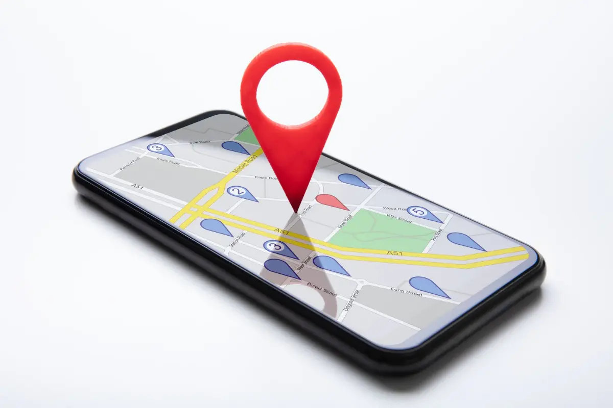 Hands holding a smartphone with Google Maps open