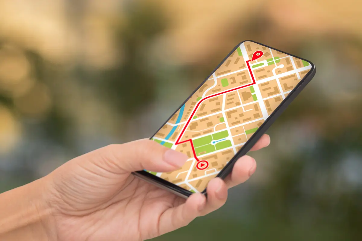 Hands holding a smartphone with Google Maps open